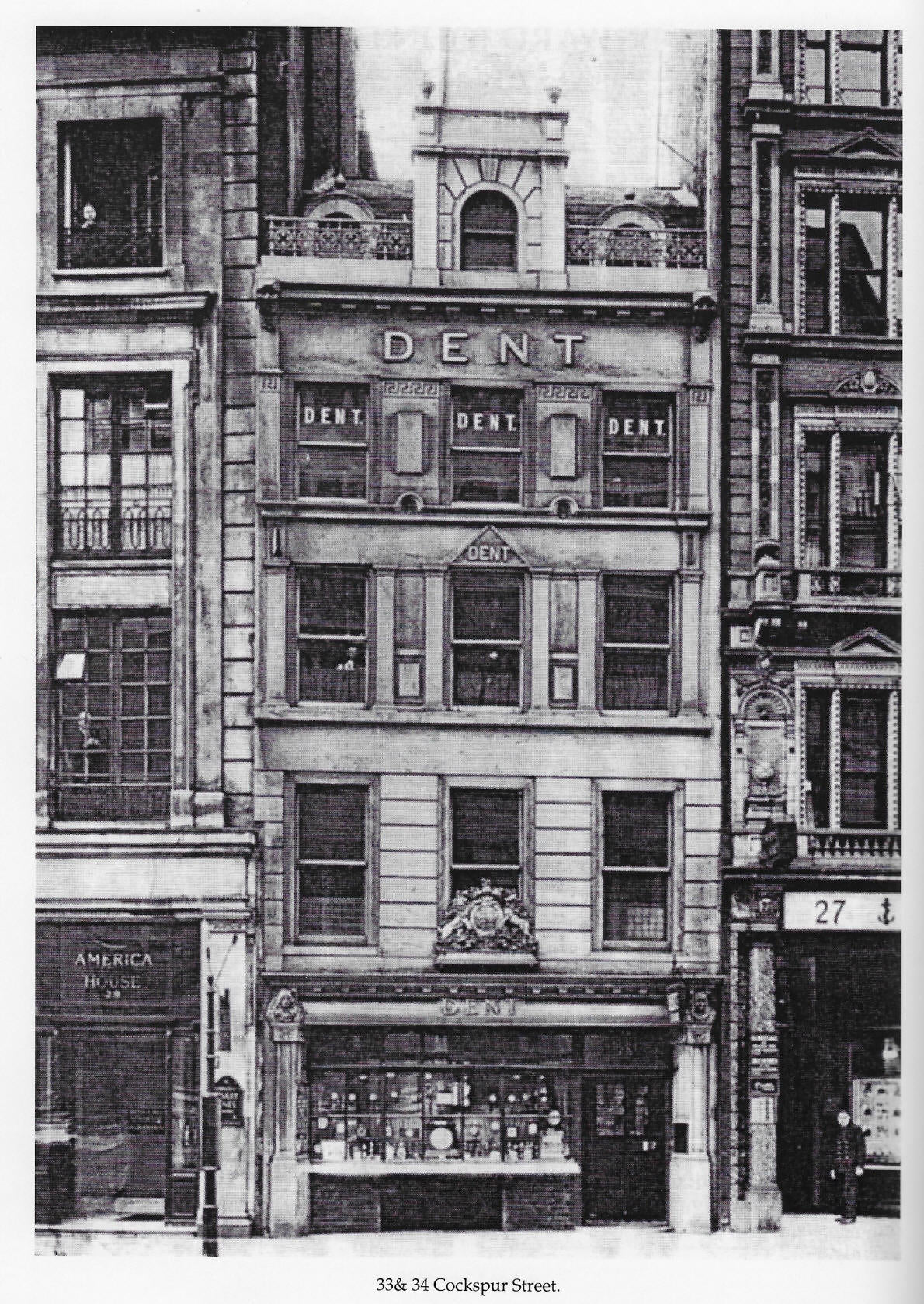 Vintage black and white photograph of a building facade with 'Dent' signage on Cockspur Street from Dent London archives.