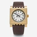 Gold Dent London St. Pancras watch with brown leather strap on a white background