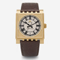 Gold Dent Parliament watch with brown leather strap on a white background